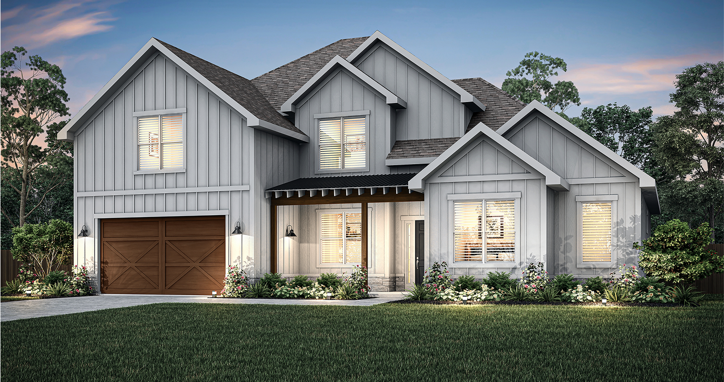 Modern two-story gray house with wood accents, double garage, front porch, illuminated windows, and landscaped yard with green grass and shrubs at dusk.